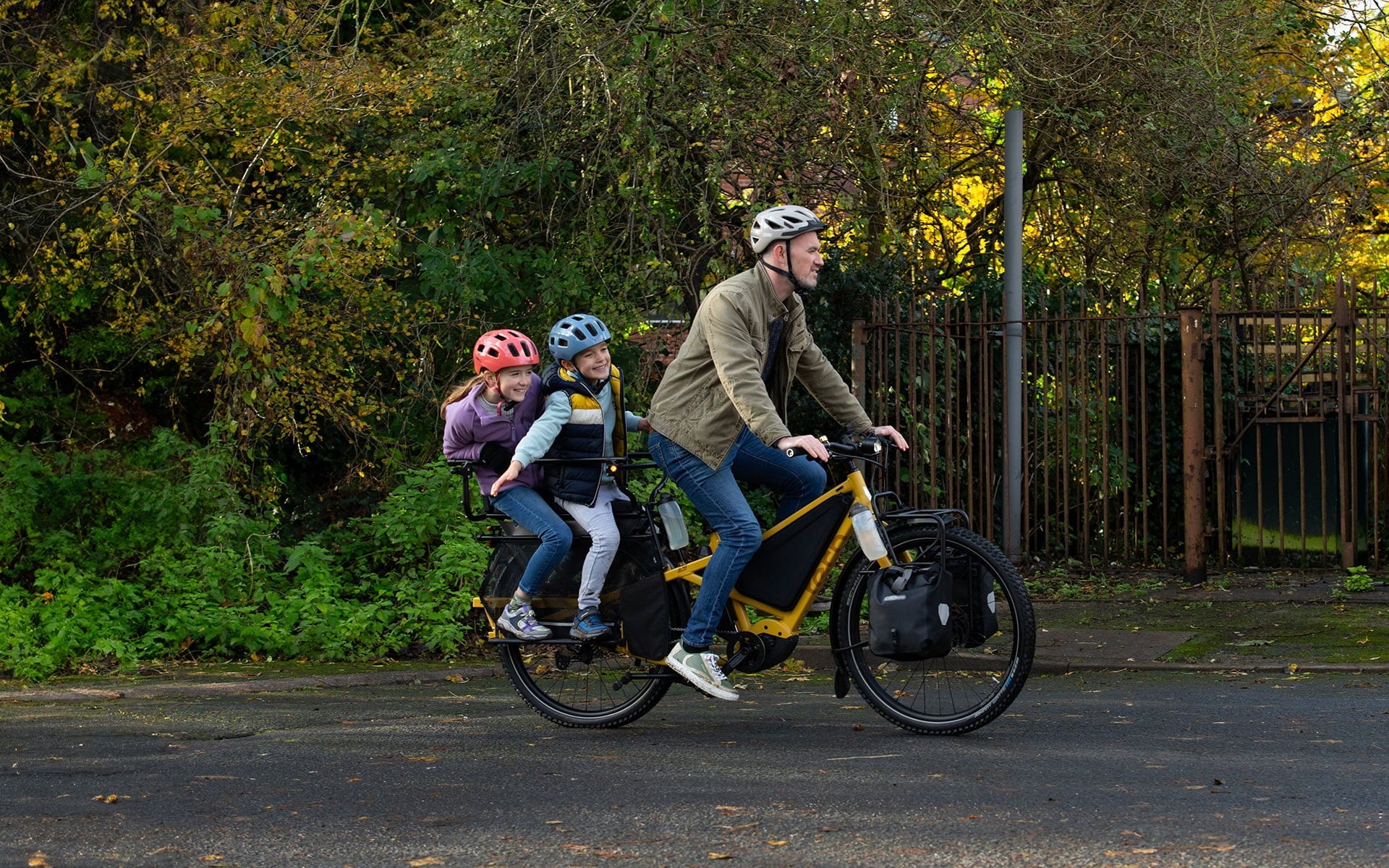 Man riding Tern Orox with two kids on the back