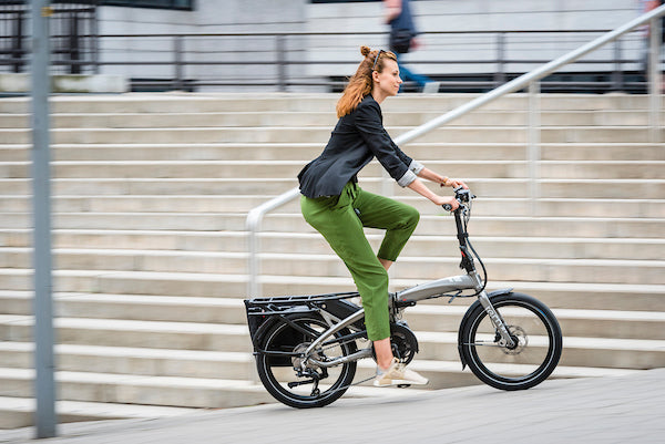 Woman riding Tern Vektron folding e-bike