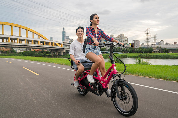 Tern e-bike with woman riding and man sitting on the back