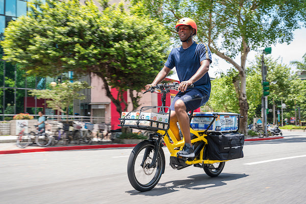 Man riding Tern cargo e-bike loaded with packages