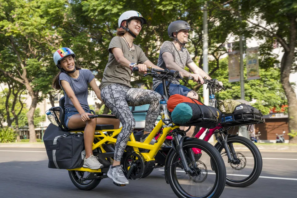 Family riding Tern GSD cargo e-bikes loaded for camping